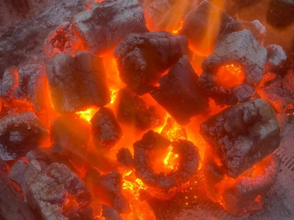 Walnut shell briquettes glowing on a grill